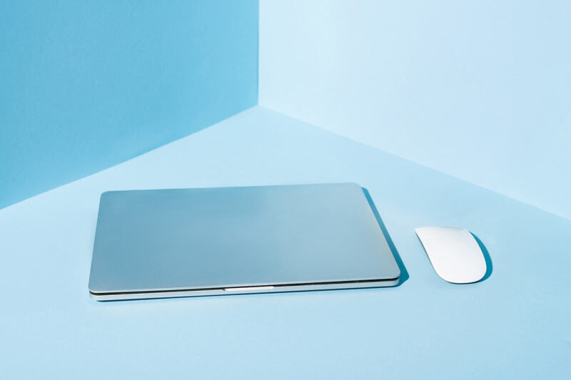 Laptop mit Maus auf einem blauen Hintergrund